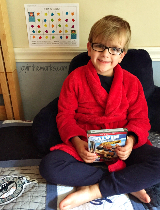 Boy fills reward star chart and picks out movie