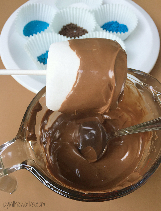 Dip a marshmallow in chocolate by spooning on the chocolate, spreading it with a knife or simply dunking it!