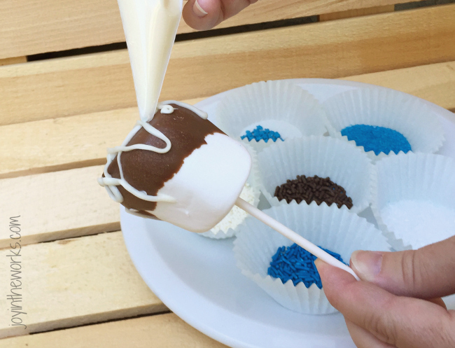 Decorate your marshmallow pops with piped icing