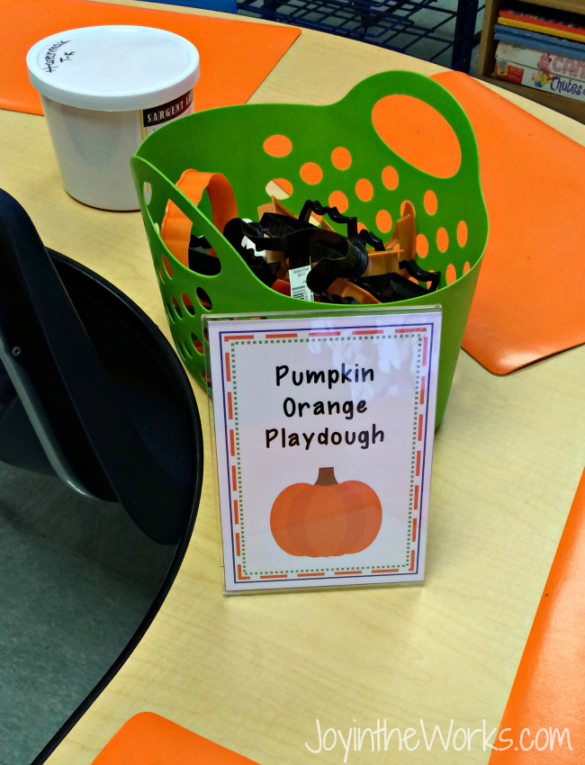 A simple, independent Halloween party activity: pumpkin orange playdough with Halloween cookie cutters
