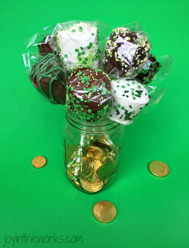 Easy DIY St. Patrick's Day Marshmallow Pops dipped in chocolate with festive green sprinkles