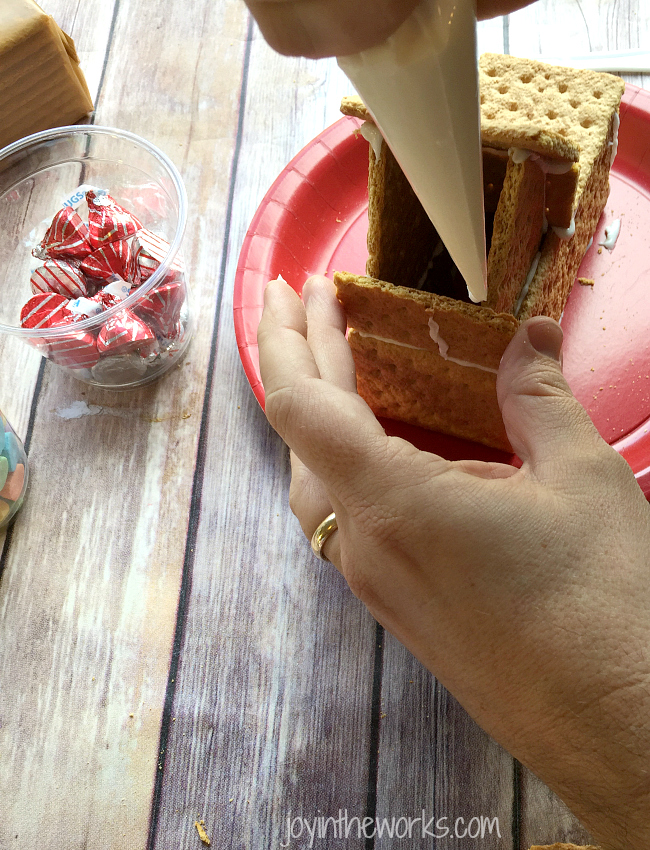 Gingerbread houses aren't just for Christmas! Why not take advantage of all the Valentine's Day candy and make a Valentine Candy House? So easy to make and so fun for the kids! A Valentine Gingerbread House would make a great Valentine's Day class party activity too!