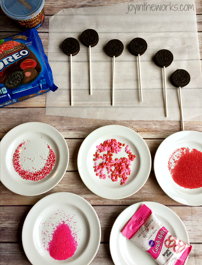 There is no better combination for Valentine's Day than strawberries and chocolate and these Valentine Oreo Pops using Chocolate Strawberry Oreos are an easy way to enjoy these flavors in a decadent Valentine's Day treat!