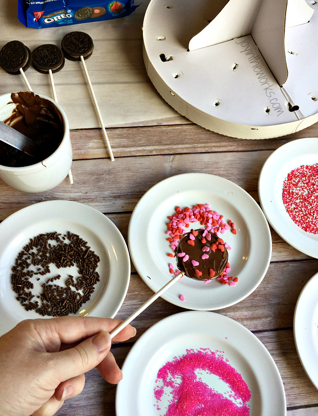 There is no better combination for Valentine's Day than strawberries and chocolate and these Valentine Oreo Pops using Chocolate Strawberry Oreos are an easy way to enjoy these flavors in a decadent Valentine's Day treat!