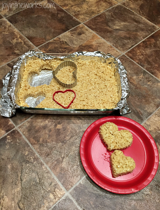 Use heart cookie cutters to cut out your heart rice krispie treats for your heart rice krispie treat pops.