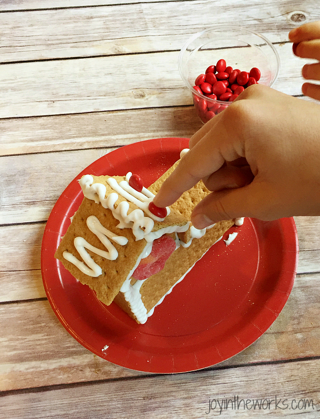 Gingerbread houses aren't just for Christmas! Why not take advantage of all the Valentine's Day candy and make a Valentine Candy House? So easy to make and so fun for the kids! A Valentine Gingerbread House would make a great Valentine's Day class party activity too!