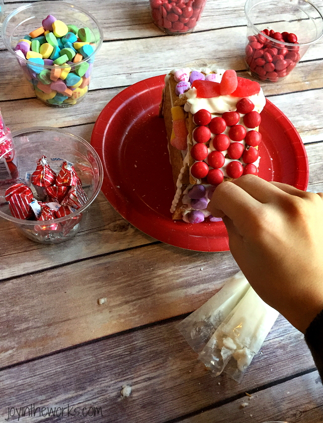 Gingerbread houses aren't just for Christmas! Why not take advantage of all the Valentine's Day candy and make a Valentine Candy House? So easy to make and so fun for the kids! A Valentine Gingerbread House would make a great Valentine's Day class party activity too!