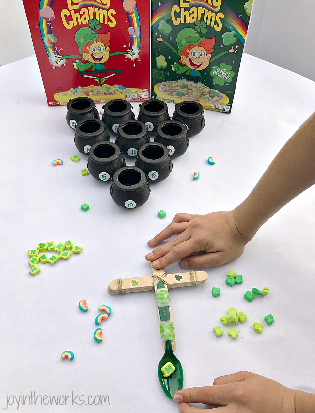 Make Lucky Charms Catapults, the perfect #STEM activity for St. Patrick's Day! Add in an extra level of fun with point values and pot of gold target practice!