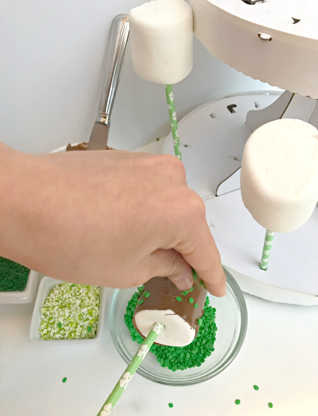 Easy DIY St. Patrick's Day Marshmallow Pops dipped in chocolate with festive green sprinkles