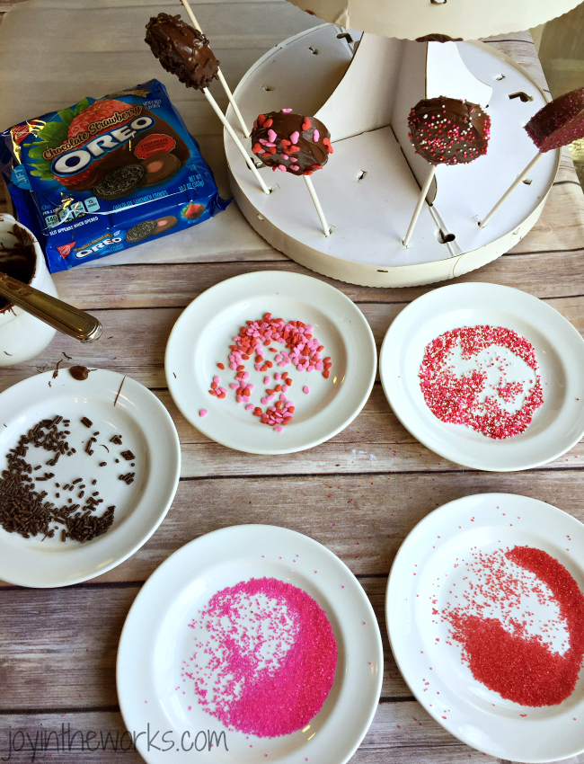 There is no better combination for Valentine's Day than strawberries and chocolate and these Valentine Oreo Pops using Chocolate Strawberry Oreos are an easy way to enjoy these flavors in a decadent Valentine's Day treat!