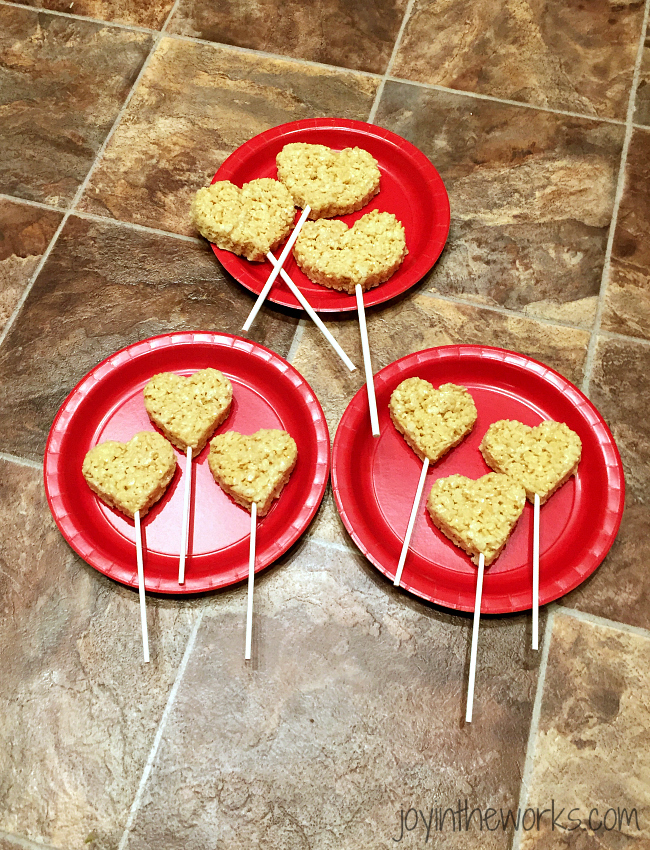 After you have cut out the heart rice krispie treats, insert cake or cookie pop sticks to make them into heart rice krispie treat pops!