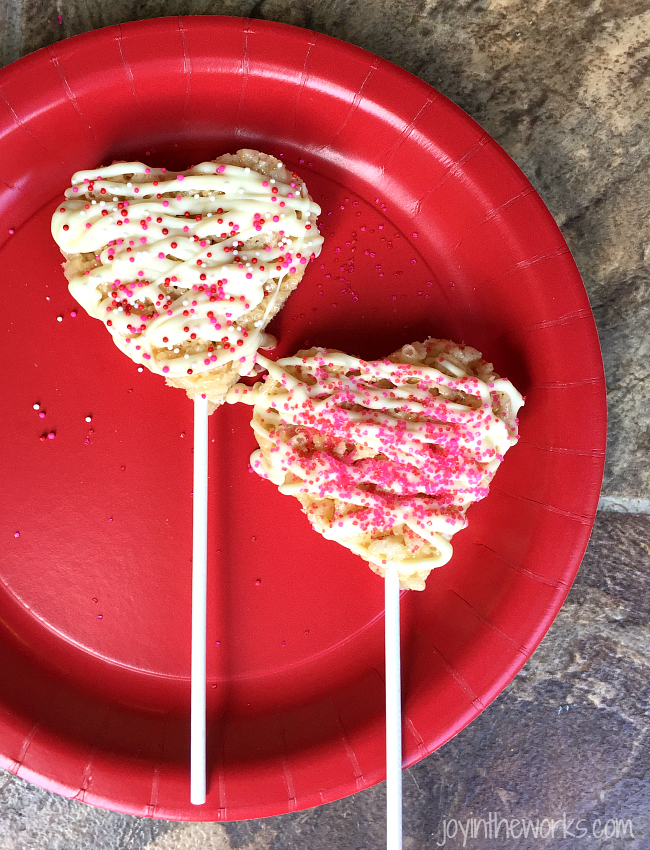 Drizzle white chocolate or chocolate on your heart rice krispie treat pops and then sprinkle with spinkles. Let harden.