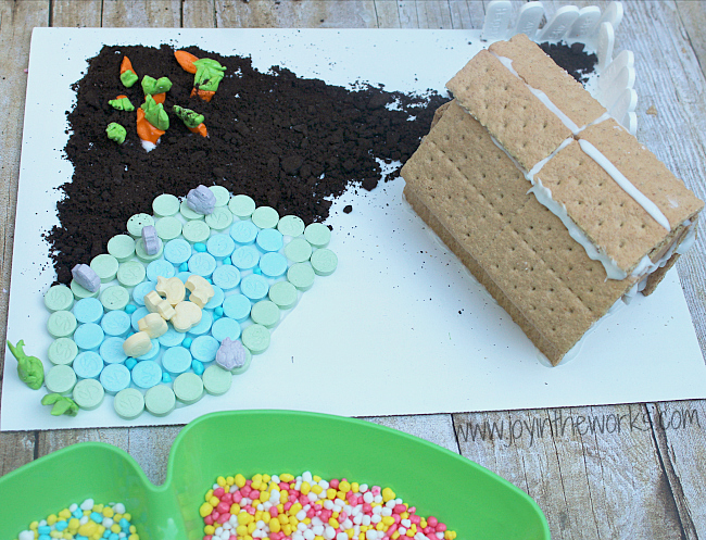 Looking for a spring family fun activity that everyone will enjoy? Make this Springtime Farm with a graham cracker barn and candy garden and pond. Decorate the roof with SweeTARTS, the garden with RUNTS, a Fun Dip Fence and SweeTARTS farm animals. Everyone will love making it (and probably eating a bit too!) #SpringItOn #NestleKitchen #CollectiveBias