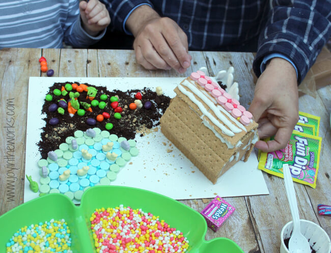 Looking for a spring family fun activity that everyone will enjoy? Make this Springtime Farm with a graham cracker barn and candy garden and pond. Decorate the roof with SweeTARTS, the garden with RUNTS, a Fun Dip Fence and SweeTARTS farm animals. Everyone will love making it (and probably eating a bit too!) #SpringItOn #NestleKitchen #CollectiveBias