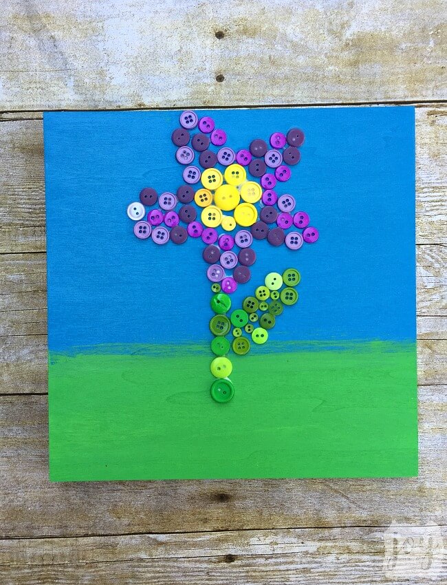 Looking for a creative DIY Mother's Day Gift or just a beautiful work of art? This button flower art project is surprisingly easy and sure to impress! It's a great homemade gift idea that an adult or an older child can make!