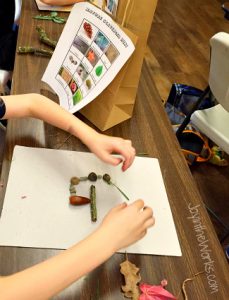 Using items from our Nature Scavenger Hunt to make letters for our Thanksgiving Banner