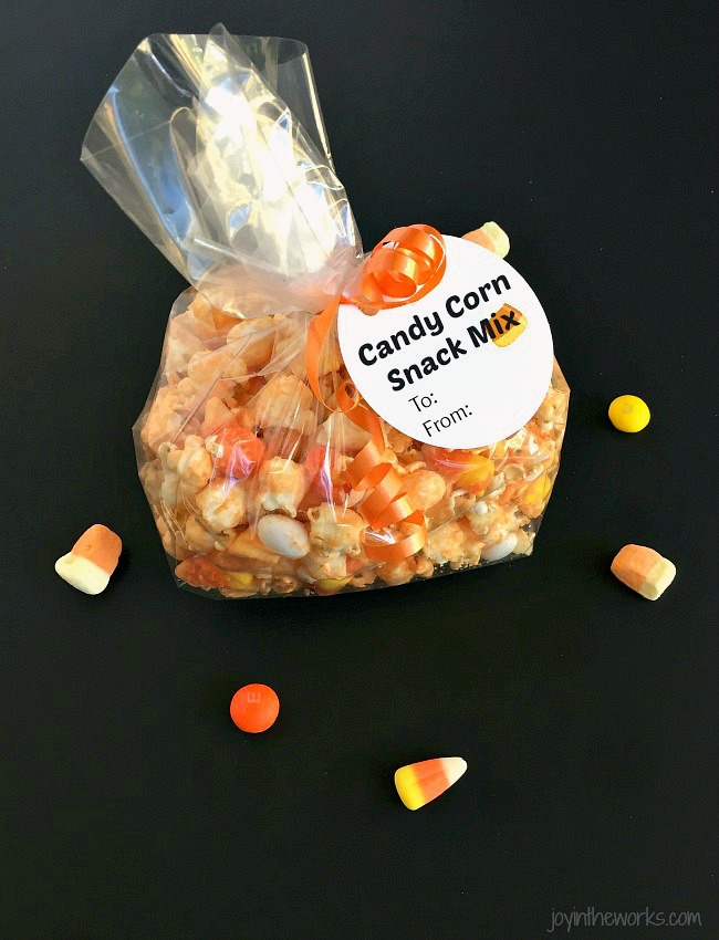 Whether you call it Candy Corn Trail Mix, Candy Corn Popcorn Mix or Candy Corn Snack Mix, this is the perfect Fall Snack for a Halloween Party or addition to a Boo Kit! Even better? It comes with a free printable Candy Corn Themed Halloween gift tag!