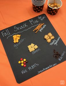 A (mostly) healthy Fall Snack Mix for kids with Goldfish Crackers, pretzels, raisins, cereal, Teddy Grahams and a small sweet treat with Fall M&M's