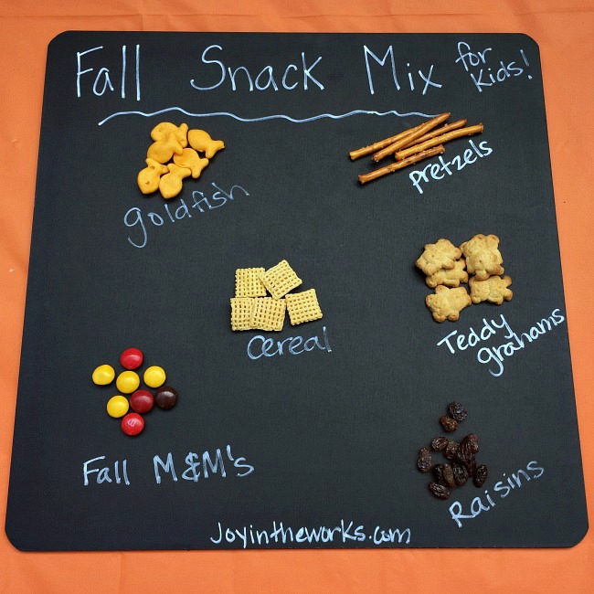 A (mostly) healthy Fall Snack Mix for kids with Goldfish Crackers, pretzels, raisins, cereal, Teddy Grahams and a small sweet treat with Fall M&M's