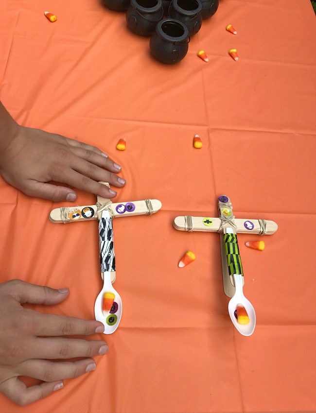 The perfect Halloween STEM activity is a Candy Corn Catapult! Even better? Try launching the candy corn, eyeballs and mini-pumpkins into cauldron targets!