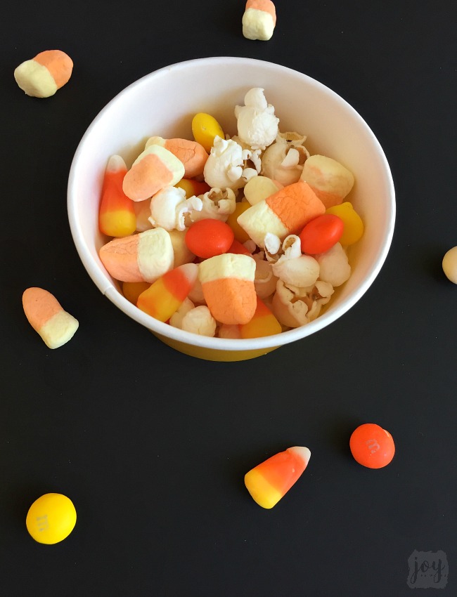 Whether you call it Candy Corn Trail Mix, Candy Corn Popcorn Mix or Candy Corn Snack Mix, this is the perfect Fall Snack for a Halloween Party or addition to a Boo Kit! Even better? It comes with a free printable Candy Corn Themed Halloween gift tag!