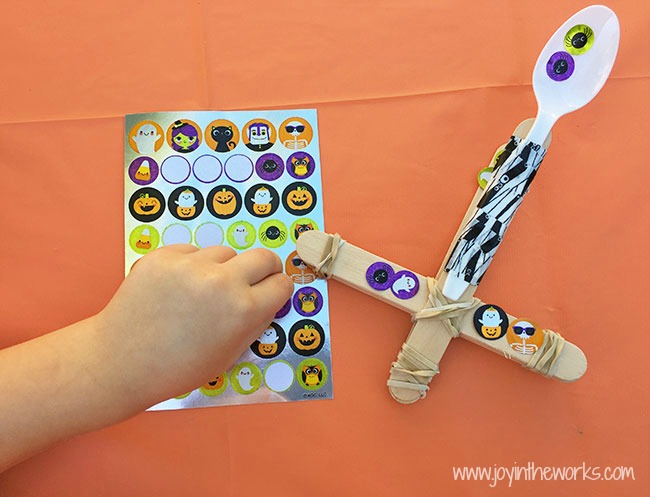 The perfect Halloween STEM activity is a Candy Corn Catapult! Even better? Try launching the candy corn, eyeballs and mini-pumpkins into cauldron targets!