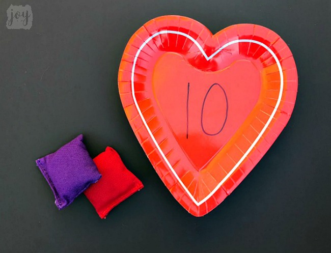 Practice addition, counting, subitizing and more with these simple Valentine themed math games using heart shaped paper plates! #valentinesday #mathgames #addition #subtraction #counting #math #handsonlearning