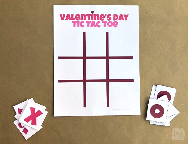 Need a quick and easy printable Valentine's Day Party Game? Valentine Themed Tic Tac Toe is always a hit, especially when you pair it with chocolate kisses or candy hearts! Download the free printable Valentine's Day game complete with game pieces or get inspired by the numerous creative game piece ideas! #valentinesdayparty #valentinesdaypartygames #kidgames #printablegame #freeprintable #tictactoe