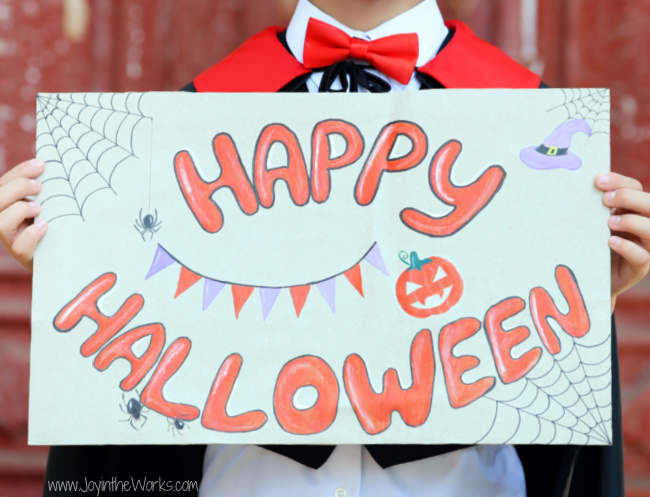 Have kids make signs and decorate posters for their Virtual Halloween Party video calls!